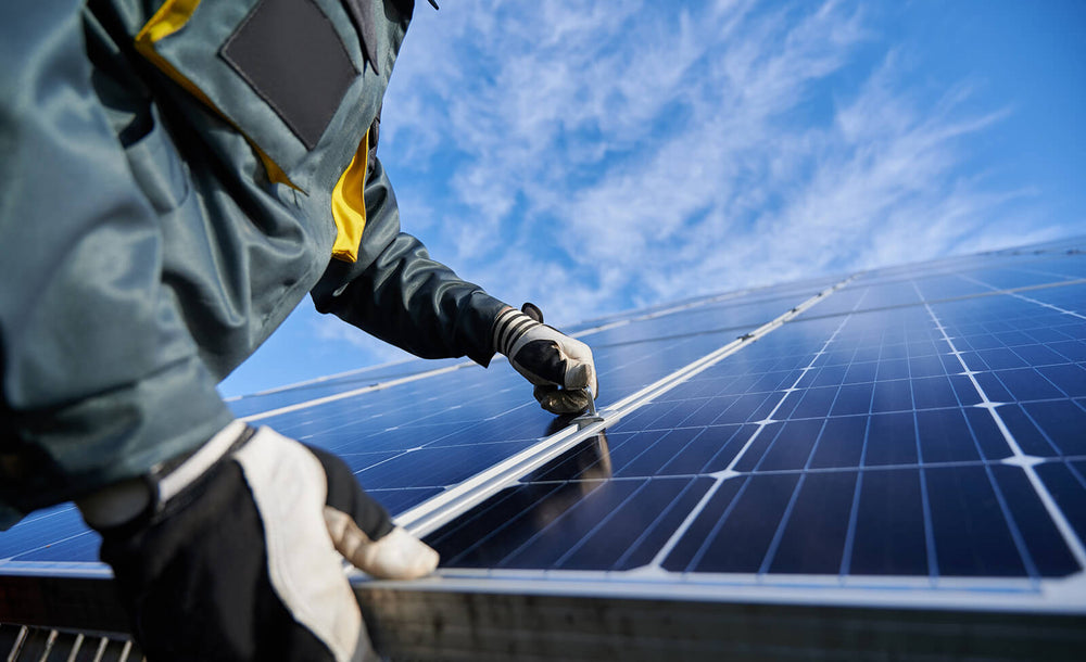 A person installing a solar panel